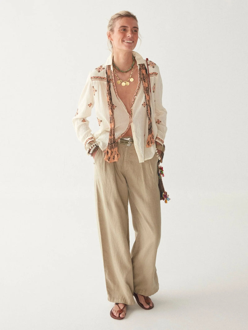 Light khaki wide leg linen trousers with pleated front zip fly and button fastening