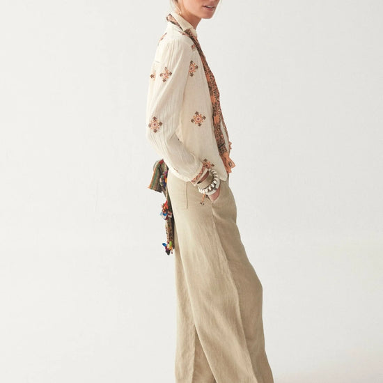 Light khaki wide leg linen trousers with pleated front zip fly and button fastening