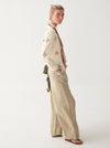 Light khaki wide leg linen trousers with pleated front zip fly and button fastening