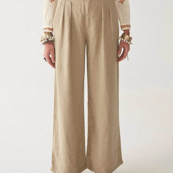 Light khaki wide leg linen trousers with pleated front zip fly and button fastening