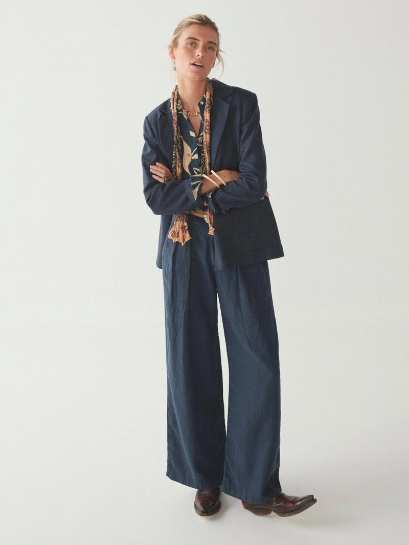 Navy wide leg linen trousers with pleated front zip fly and button fastening