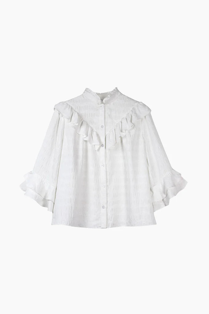 White ruffle blouse with high ruffle collar, V shaped ruffle on the yoke and three quarter length sleeves with ruffle details