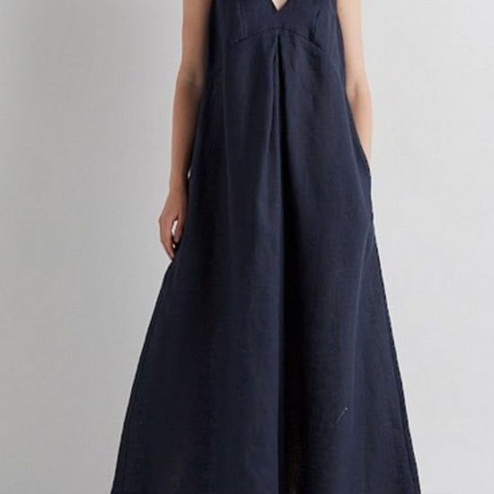 Woman wearing a navy blue sleeveless jumpsuit against a plain background from Mei MeiJ