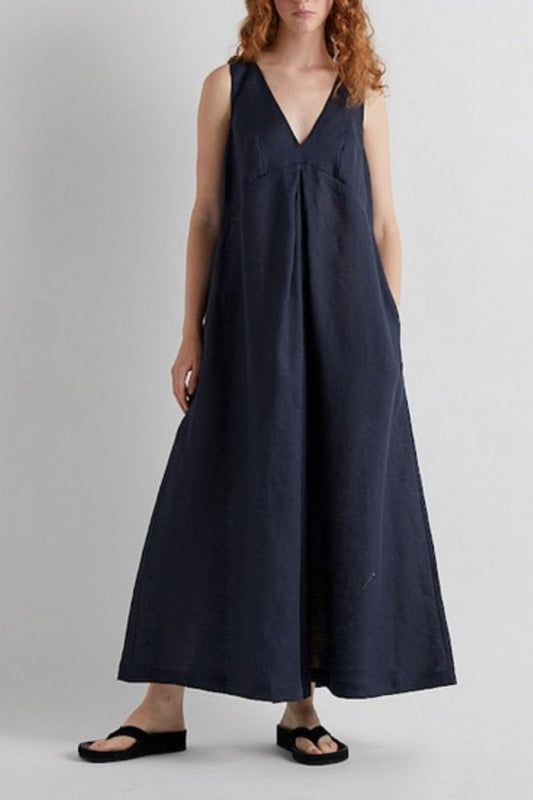 Woman wearing a navy blue sleeveless jumpsuit against a plain background from Mei MeiJ