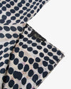 silk scarf with black polka dots close up