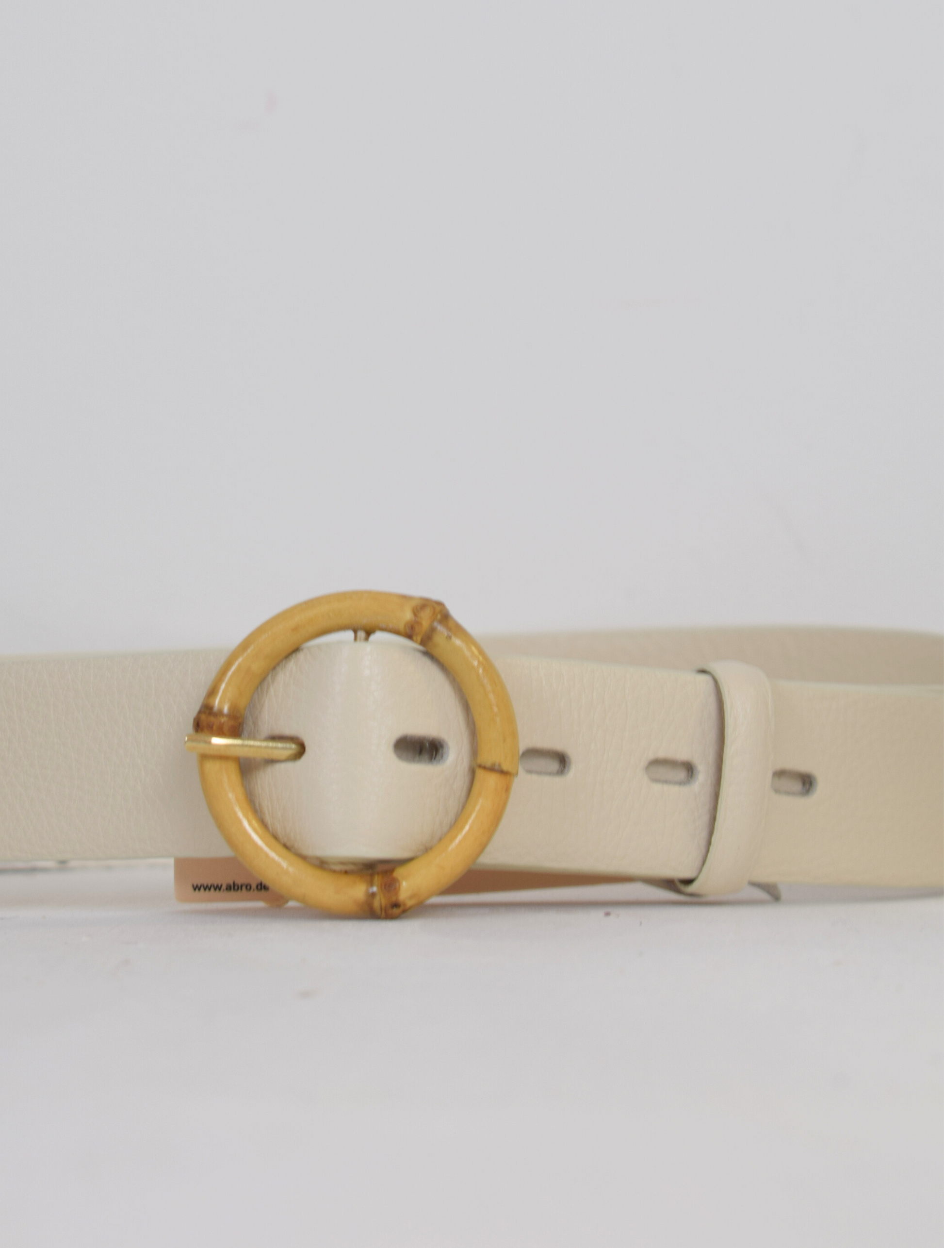 Cream belt with circular buckle