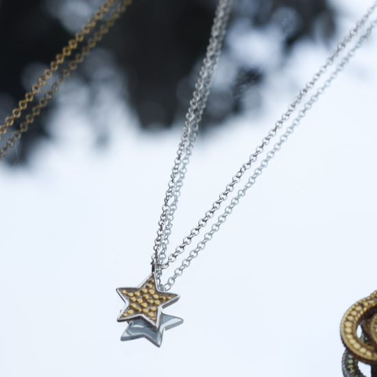 Silver chain with star pendant with small gold dots