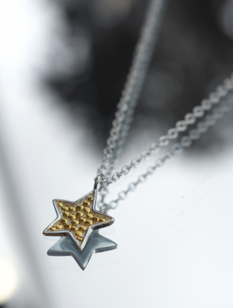 Silver chain with star pendant with small gold dots