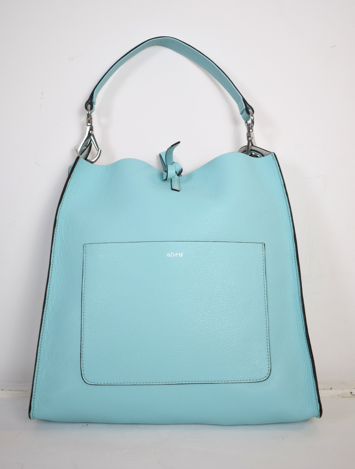 Pale blue leather bag. With a handle and a cross body strap.