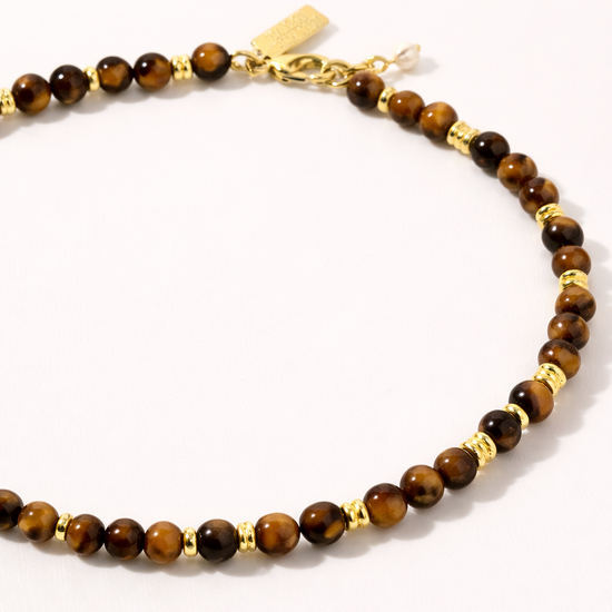Beaded necklace with gold accents on a white background