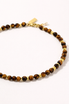 Beaded necklace with gold accents on a white background