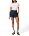 Person wearing dark denim shorts and a white t-shirt on a white background