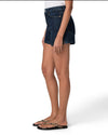 Person wearing dark blue denim shorts on a white background