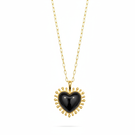 black agate heart shaped pendant with gold spike edging on a gold chain from talis chains