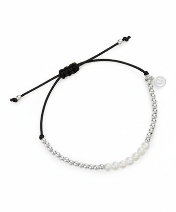 Bracelet with pearls and a black cord on a white background