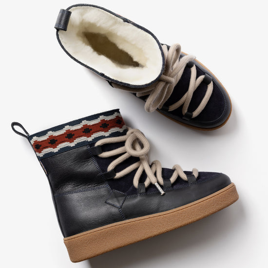 view of inside of navy boots with fluffy inside 