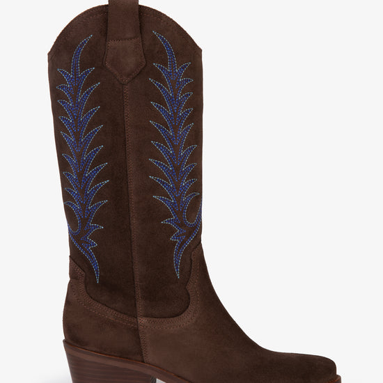 Brown cowboy boot with blue embroidery on white background