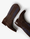 Brown cowboy boot with blue embroidery on white background laying down