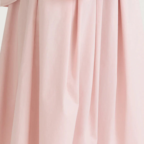 Close-up of a light pink fabric with a soft texture on a white background