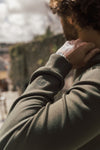 dark green round neck sweatshirt close up