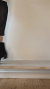 Model wearing black leather with small heel boots shown at different angles.