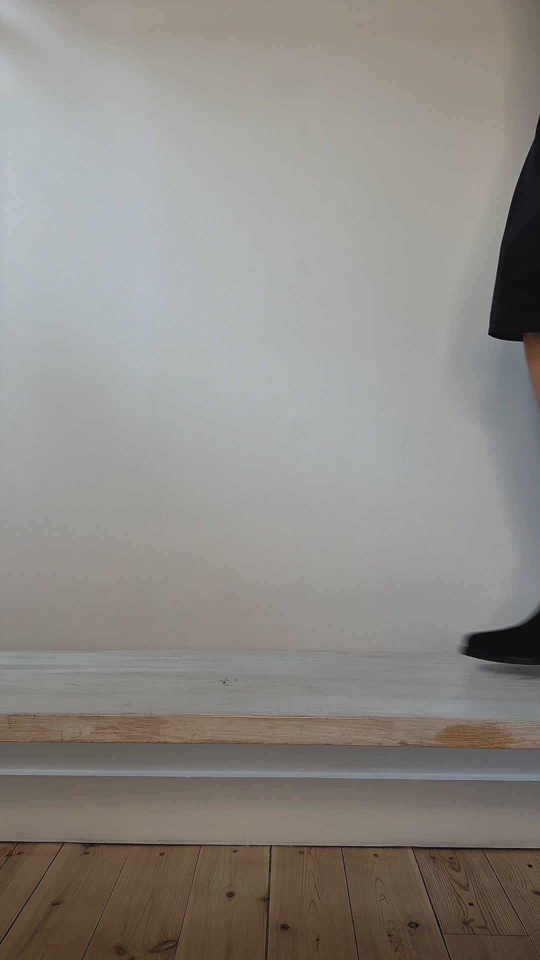 Model wearing  black suede Chelsea-style ankle boots with elastic side panels and low block heels shown at different angles. 