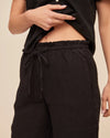 Close up of waistband of black wide leg trousers