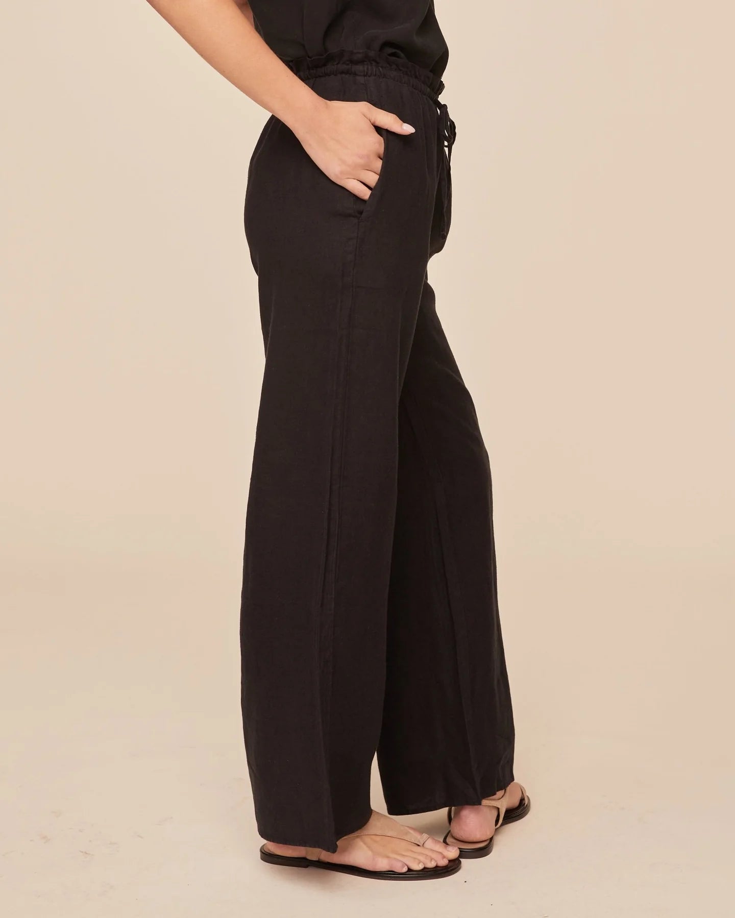 Side view of black wide leg trousers