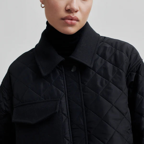 diamond stitch black coat with cool 
collar, chest pocket and straps on cuffs 