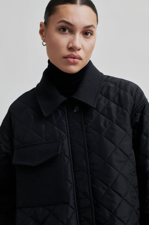 diamond stitch black coat with cool 
collar, chest pocket and straps on cuffs 