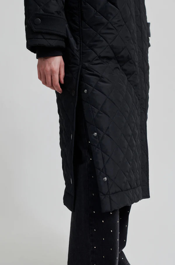 diamond stitch black coat with cool 
collar, chest pocket and straps on cuffs  close up