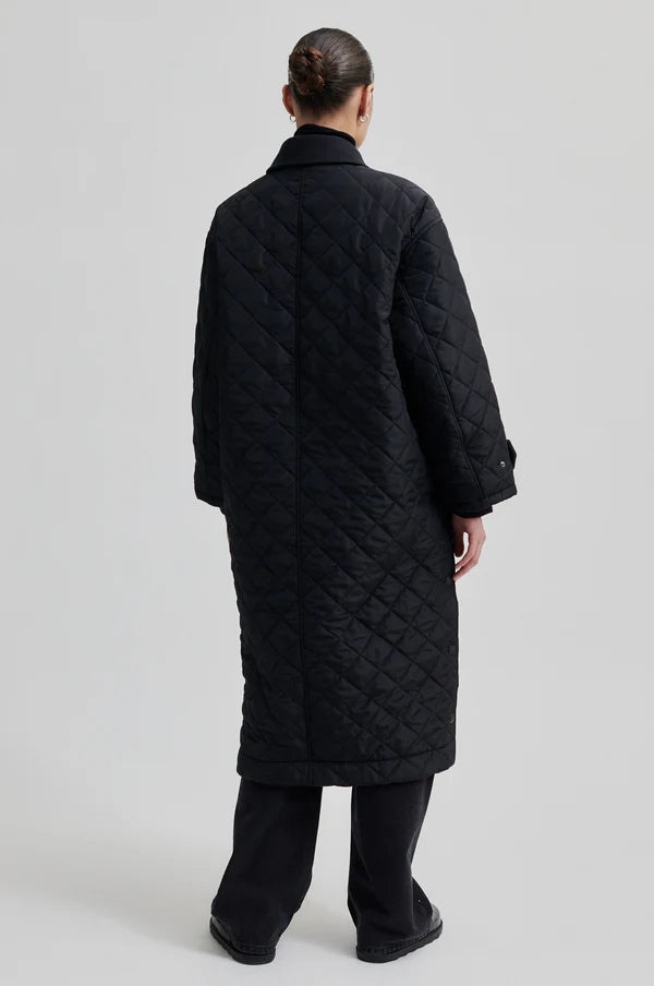 diamond stitch black coat with cool 
collar, chest pocket and straps on cuffs  rear view 