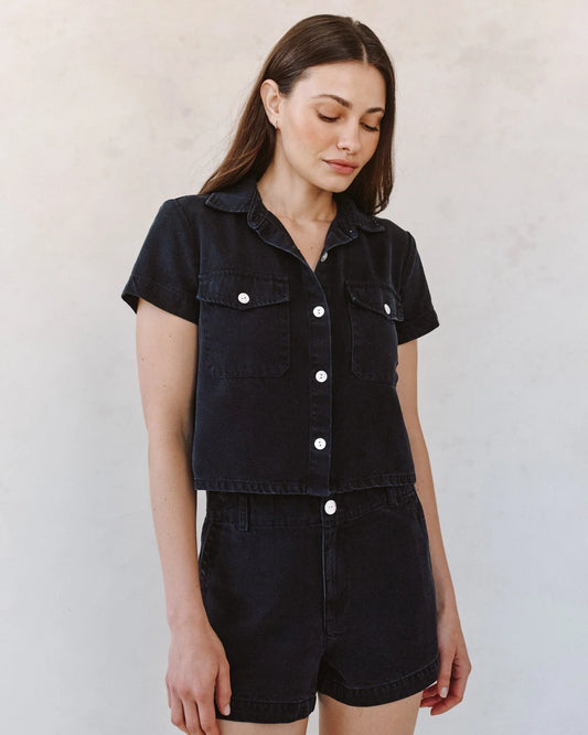 woman wearing black denim short sleeve shirt with white background - full outfit