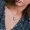 White gold plated sterling silver necklace with a diamond studded pave crescent 