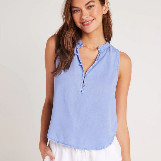 Cornflower blue sleeveless top with stand up collar and edge to edge button fastening