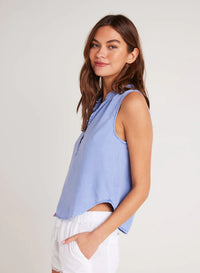 Cornflower blue sleeveless top with stand up collar and edge to edge button fastening