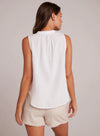 White sleeveless top with stand up collar and edge to edge button fastening along a half placket
