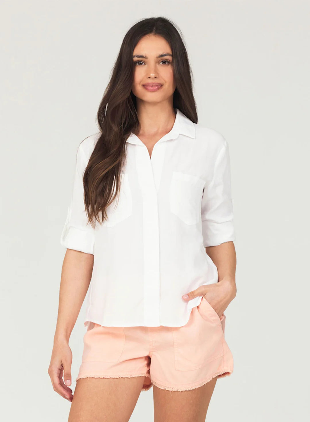 White shirt with classic colalr and covered placket with turn up cuffs and two front chest pockets