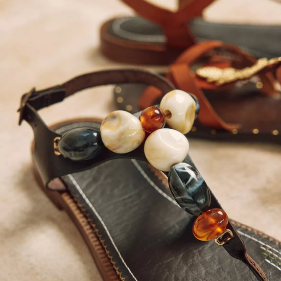 brown sandals with stone detail close up 