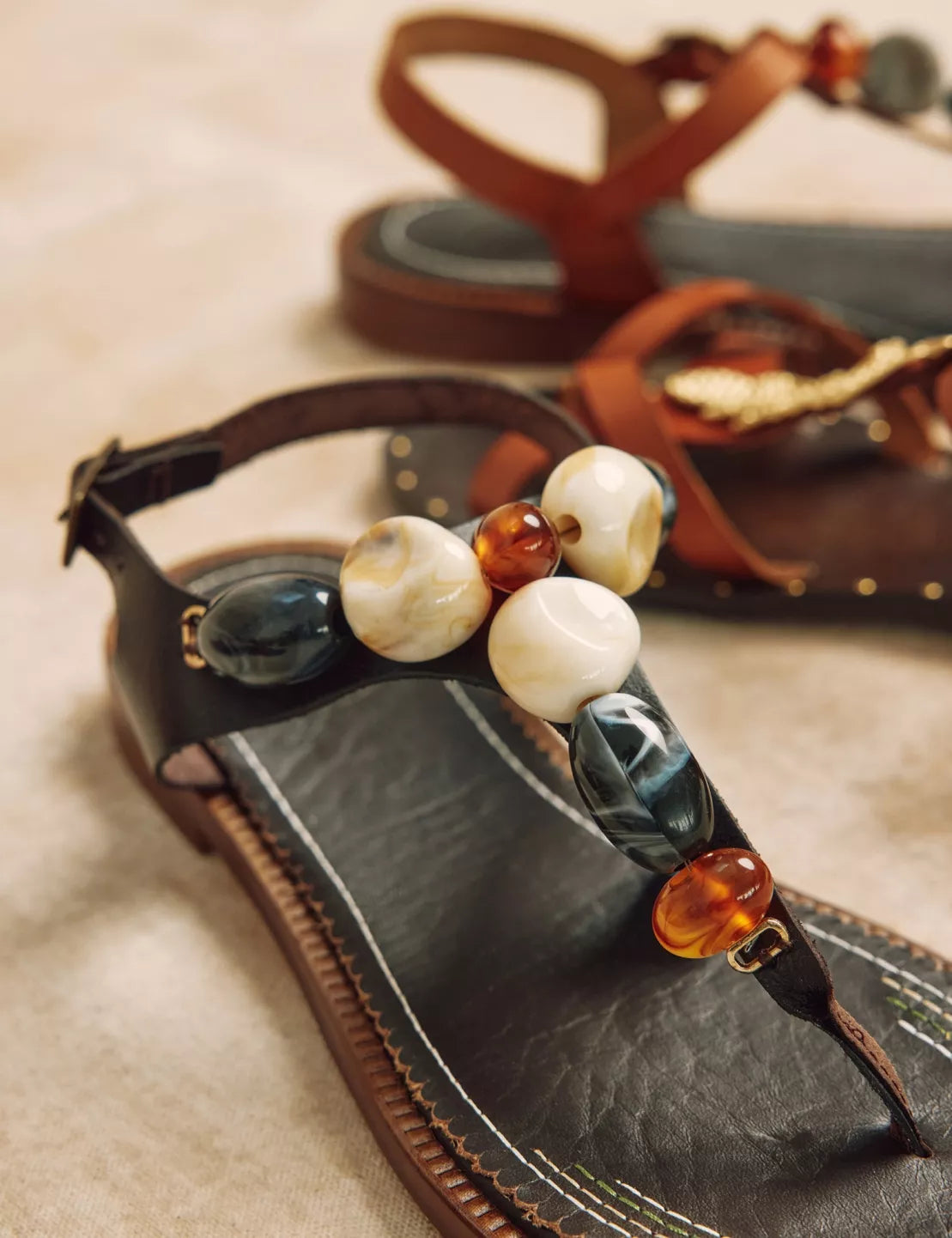 brown sandals with stone detail close up 
