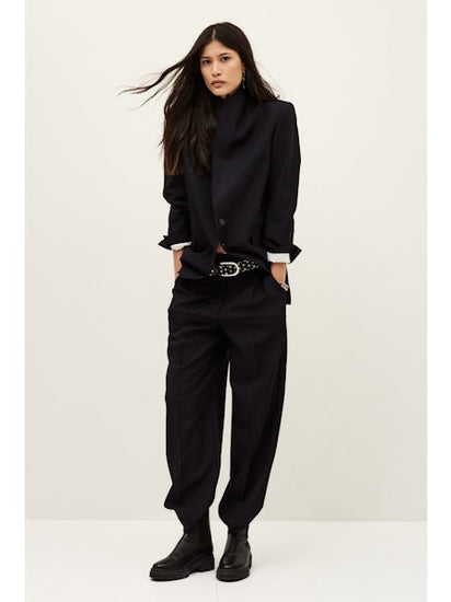 Woman wearing dark navy suit from Parisian brand ba&sh