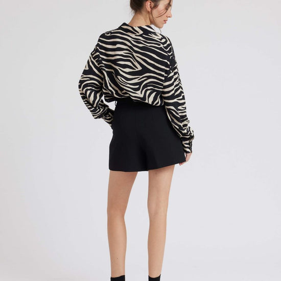 Zebra print shirt with long sleeves and a curved dropped hem