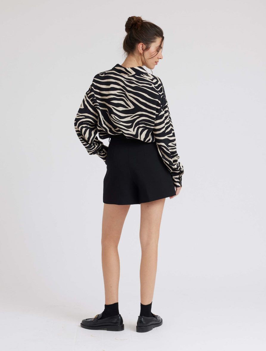 Zebra print shirt with long sleeves and a curved dropped hem