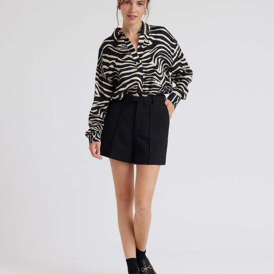 Zebra print shirt with long sleeves and a curved dropped hem