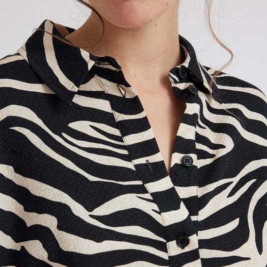 Zebra print shirt with long sleeves and a curved dropped hem