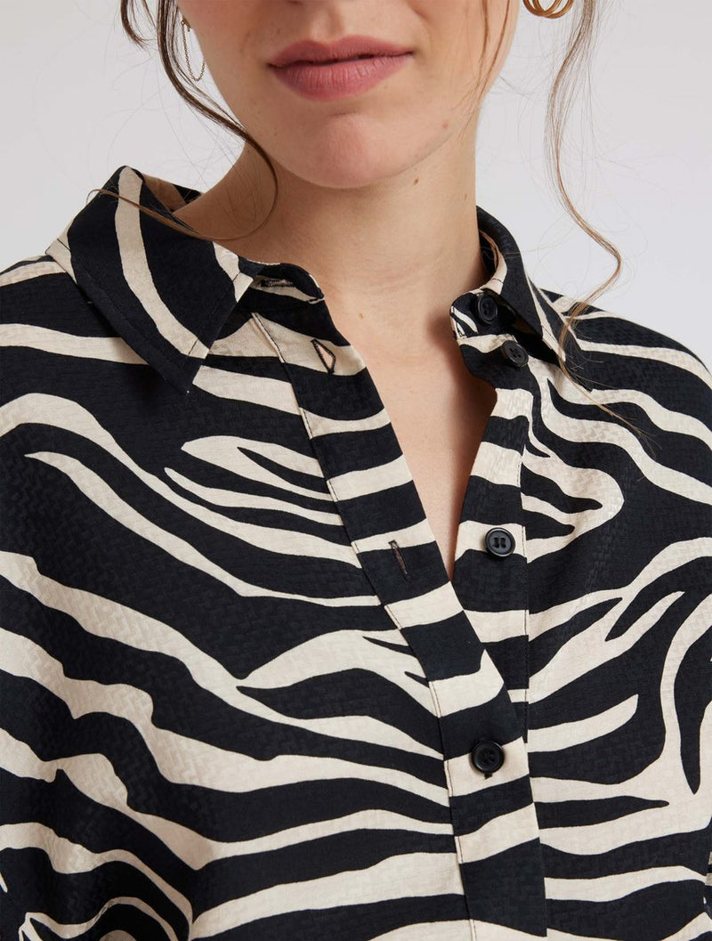 Zebra print shirt with long sleeves and a curved dropped hem