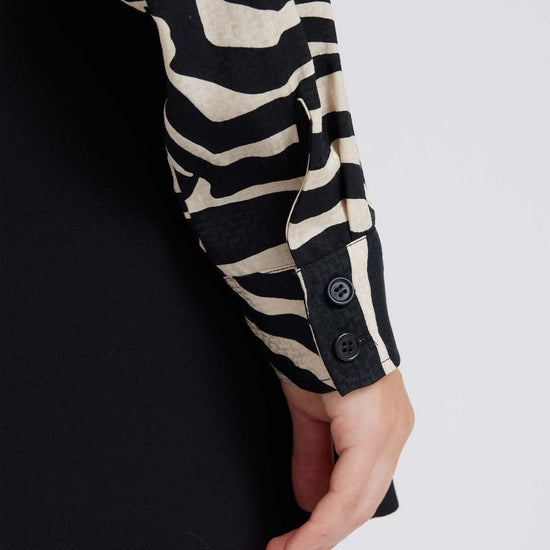 Zebra print shirt with long sleeves and a curved dropped hem