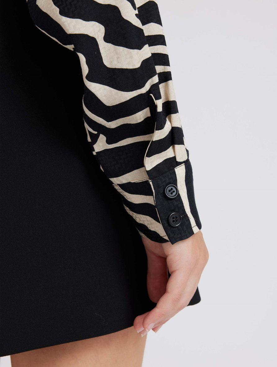 Zebra print shirt with long sleeves and a curved dropped hem