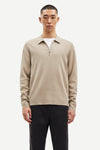 beige half zip polo jumper with classic collar and long sleeves model shot