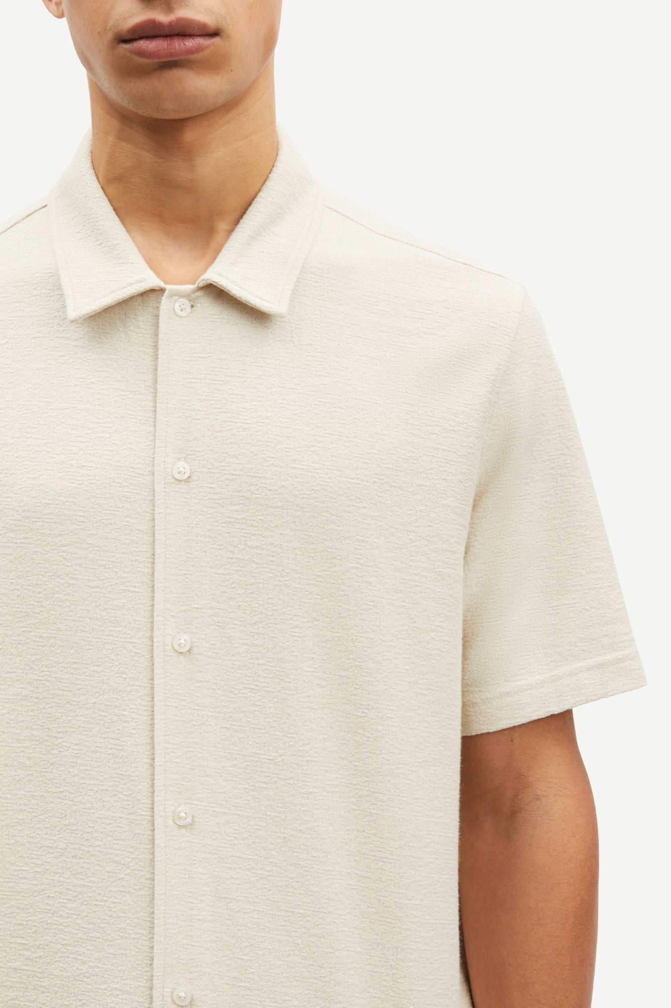 oatmeal short sleeved shirt with point collar in a slubbed textured material close up